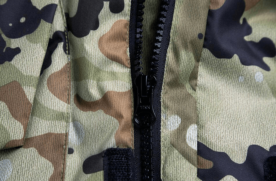 Close-up of camouflage waterproof men's snowboard jacket with zipper, showcasing the durable fabric and design.